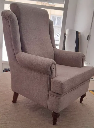 Sillón orejero terminado tapizado en gris taupe